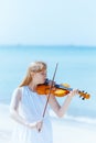 modern teenage girl in light dress enjoying playing on seacoast Royalty Free Stock Photo