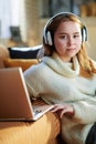 Modern teenage girl listening to music while and laptop Royalty Free Stock Photo