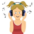 Modern teenager girl listening to music in headphones