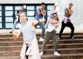 Modern teenager performing street dance with group