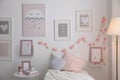 Modern teenager`s room with comfortable bed and beautiful pictures Royalty Free Stock Photo