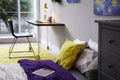 Modern teenager`s room with comfortable bed, workplace and stylish design elements Royalty Free Stock Photo