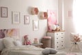 Modern teenager`s room interior with bed and beautiful pictures Royalty Free Stock Photo
