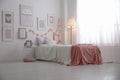 Modern teenager`s room interior with bed and beautiful pictures Royalty Free Stock Photo