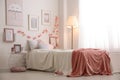 Modern teenager`s room with comfortable bed and beautiful pictures Royalty Free Stock Photo