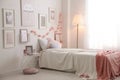 Modern teenager`s room with comfortable bed and beautiful pictures Royalty Free Stock Photo
