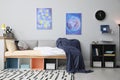 Modern teenager`s room with comfortable bed and stylish design elements Royalty Free Stock Photo