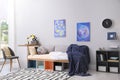 Modern teenager`s room interior with bed and stylish design elements Royalty Free Stock Photo