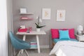 Modern teenager`s room interior with comfortable bed and workplace Royalty Free Stock Photo