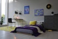 Modern teenager`s room with comfortable bed, workplace and stylish design elements Royalty Free Stock Photo