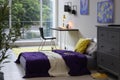 Modern teenager`s room with comfortable bed, workplace and stylish design elements Royalty Free Stock Photo