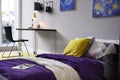 Modern teenager`s room interior with comfortable bed, workplace and stylish design elements Royalty Free Stock Photo