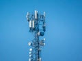 A modern telecommunications tower stands tall against a clear blue sky Royalty Free Stock Photo