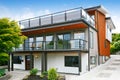 Modern three level house exterior with wooden trim Royalty Free Stock Photo