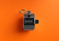 Modern timer on orange background, top view