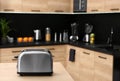 Modern toaster on table in kitchen Royalty Free Stock Photo