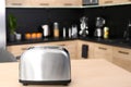 Modern toaster on table in kitchen Royalty Free Stock Photo