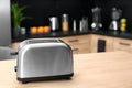 Modern toaster on table in kitchen Royalty Free Stock Photo