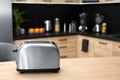 Modern toaster on table in kitchen Royalty Free Stock Photo