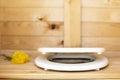 Modern toilet seat with a slowly closing lid in a rustic, wooden restroom WC, in the background a bouquet of dandelions Royalty Free Stock Photo