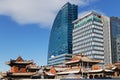 Modern towers and a traditional monastery roofs