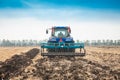 Modern tractor in the field on a sunny day.