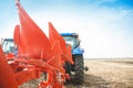 A modern tractor with a trailed plow on the field on a sunny day. Royalty Free Stock Photo