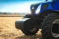 Modern tractor working in a field close-up. Royalty Free Stock Photo