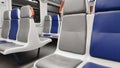 Modern train interior featuring clean seats in gray and blue with minimalistic design. Royalty Free Stock Photo