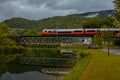 Modern train running over metal trestle bridge at Reichraming, A Royalty Free Stock Photo