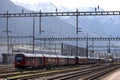 Modern trains of the rhÃÂ¤tische bahn at landquart in front of the swiss alps