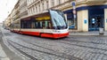 Modern tram in Prague. New public transport in Europe. Cobblestone street