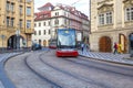 Modern trams on main square of Prague`s Mala Strana next to St. Nicholas Church, Prague Royalty Free Stock Photo