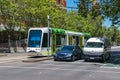 Modern tramway and cars on road crossing in Melbourne. Public transport Victoria