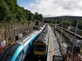 Modern transpennine train passing older train