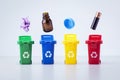 Modern trash bins with sorted garbage on light grey background. Separation of waste cans for recycling. Royalty Free Stock Photo