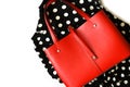 Red leather handbag on polka dot textile