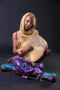 Modern Tribal Woman sitting with a drum