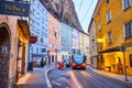 The modern trolleybus runs along curved Gstattengasse street in Salzburg, Austria