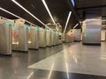 Modern turnstile gate system with illuminated access indicators at metro station, emphasizing advanced public transport Royalty Free Stock Photo