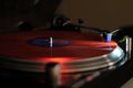 Modern turntable with red vinyl