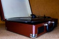 modern turntable with a vinyl record in a low light