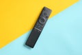 A modern TV remote control on pastel background. Top view, minimalism. Royalty Free Stock Photo