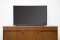 Modern TV set with empty blank screen on the wooden cabinet Royalty Free Stock Photo