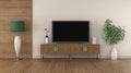 Modern TV on vintage sideboard in a white and wooden room