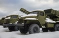 Modern types of multiple rocket launchers in the parking lot after snowfall