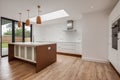 Modern unfurnished new kitchen with peninsular island and bifold doors