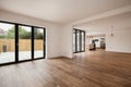 Modern unfurnished open plan sitting room with bifold doors