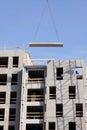 Modern urban building under construction with crane and blue sk Royalty Free Stock Photo