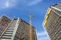 Modern urban buildings under construction with a crane and blue sky Royalty Free Stock Photo